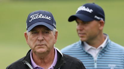 Jay Haas with his son, Bill, in the background