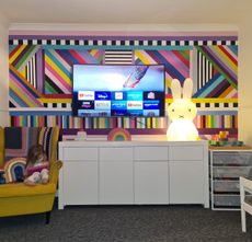 a brightly coloured living room wall painted using samples and masking tape
