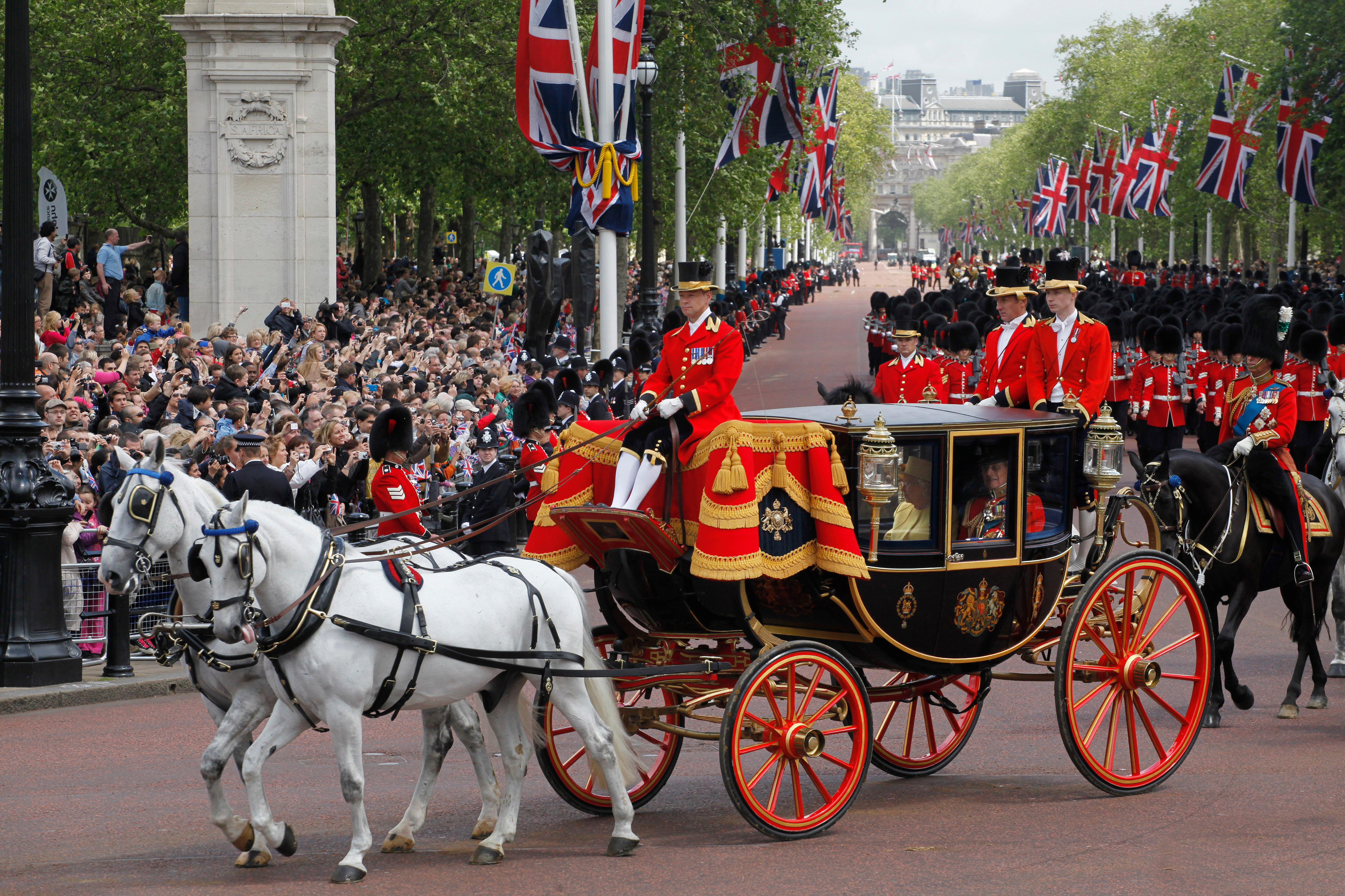 Elizabeth II and Prince Philip return to Buckingham Palace in a royal carriage