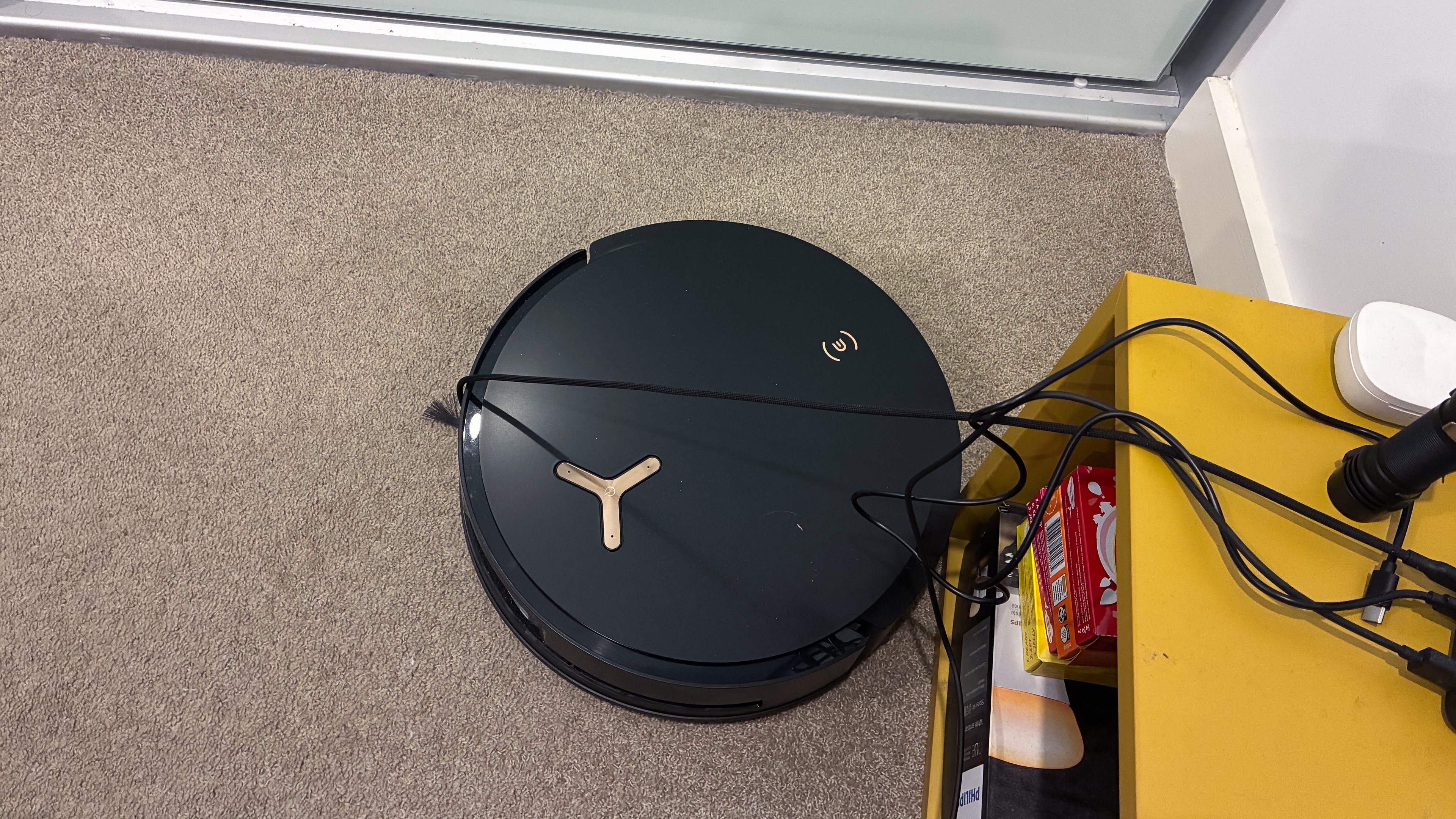 The Ecovacs Deebot X8 Pro Omni tangled on a cable
