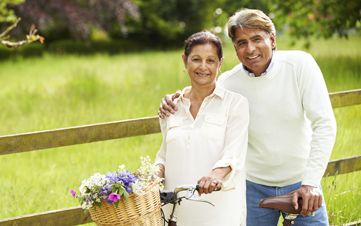 Senior Indian Couple On Cycle Ride In Countryside