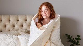 A person wrapped up in the Woolroom Deluxe Washable Wool Duvet