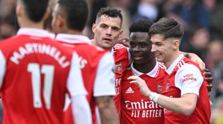 Bukayo Saka of Arsenal celebrates with his teammates after scoring the side's fourth goal during the Premier League match between Arsenal and Crystal Palace at the Emirates Stadium on March 19, 2023 in London, United Kingdom.