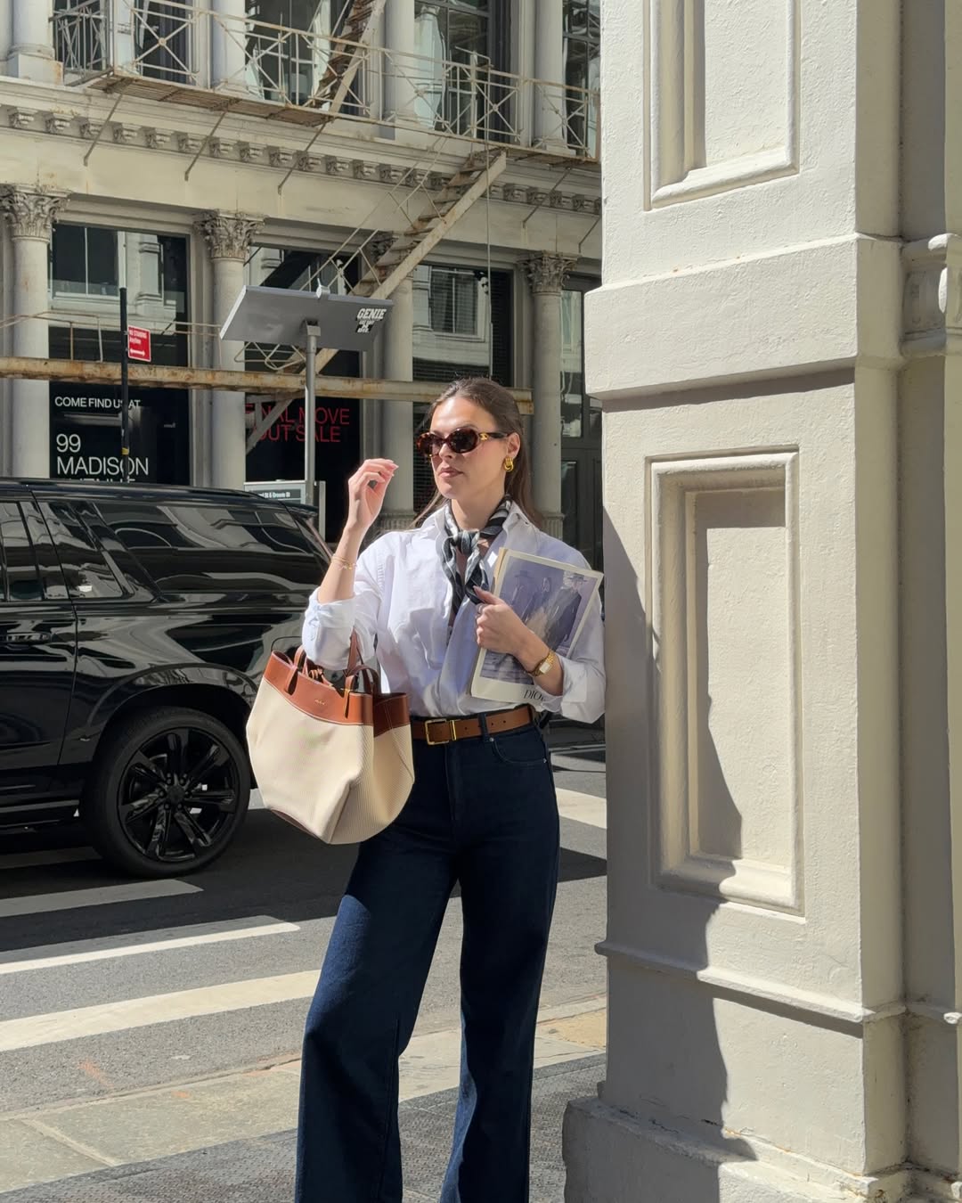 @maggie_mccormack wears wide-leg jeans, a white button-up shirt, blue and white neck scarf with a canvas tote