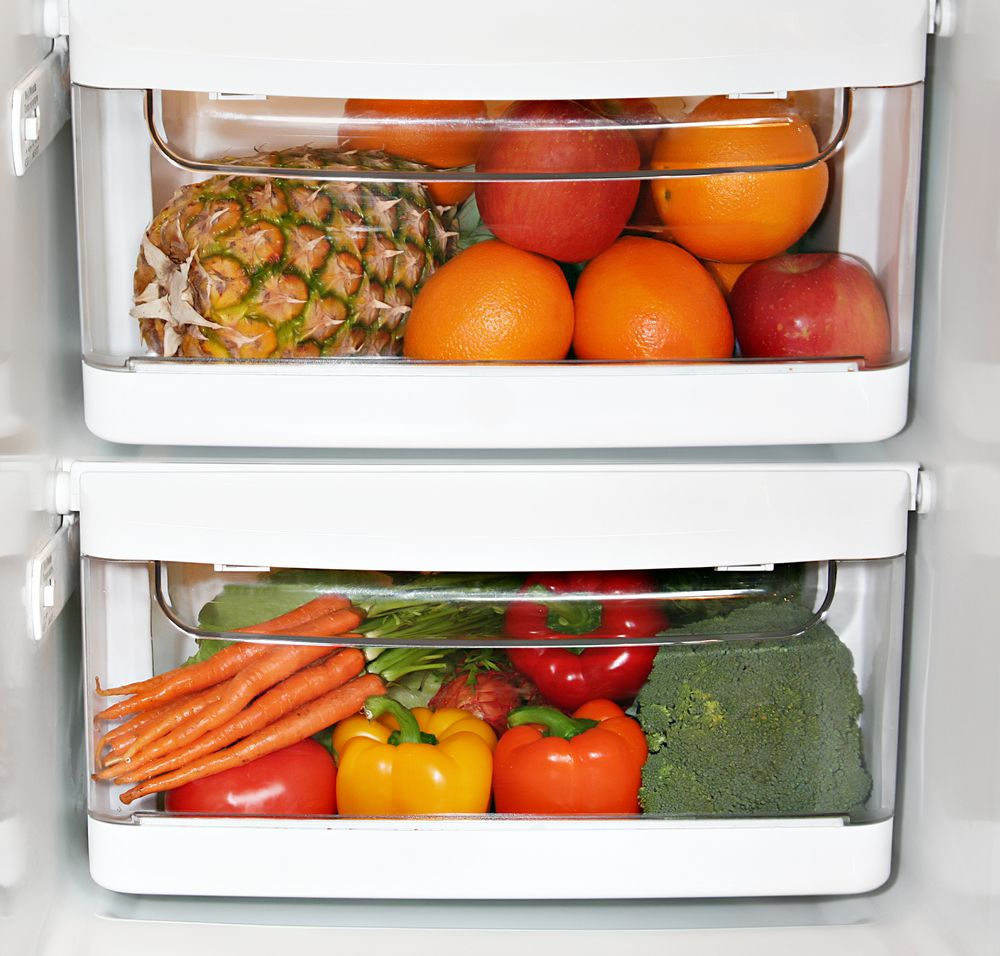 Fruits and veggies in clear drawers in the fridge