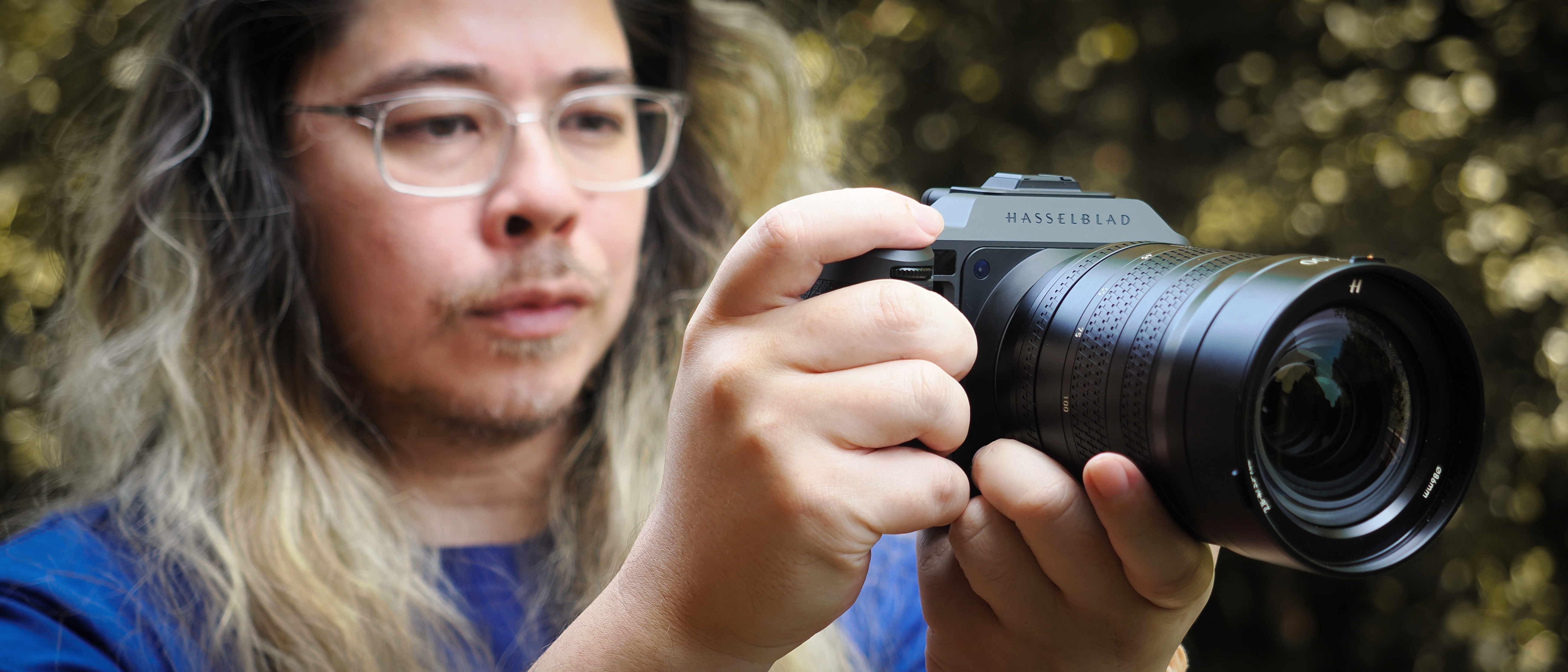 Photographer James Artaius holding a Hasselblad X2D II 100C with Hasselblad XCD 35-100E