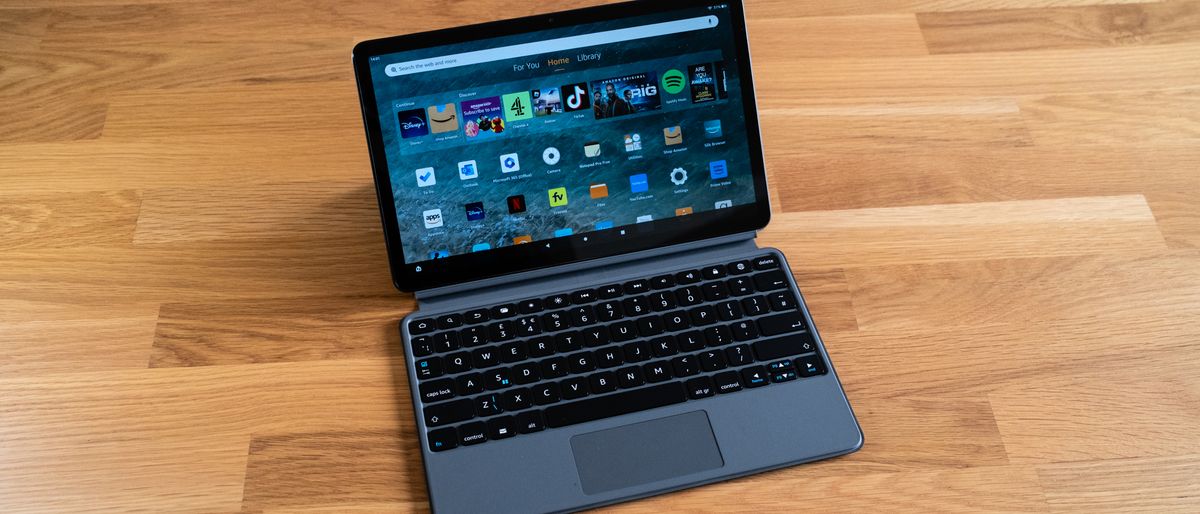 Amazon Fire Max 11 tablet with keyboard attached on a wooden surface