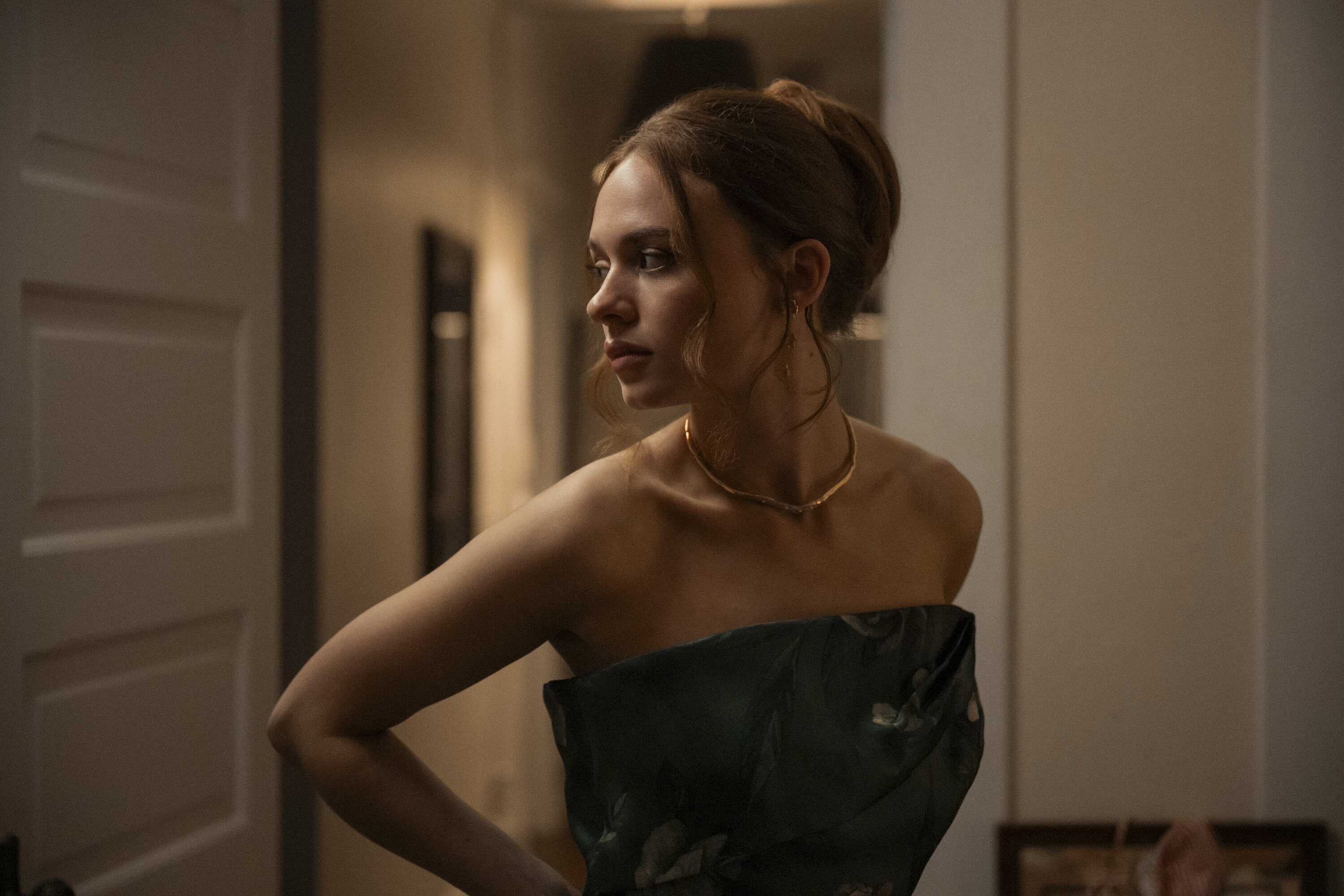 Sadie Soverall as Percy buttoning her sleeveless dress in a scene from 'Every Year After.'