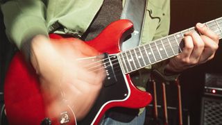A glam shot of a cherry red Epiphone Inspired By Gibson Firebird Les Paul Special in action