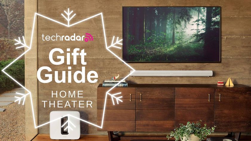 sonos arc soundbar mounted on wall beneath TV with Sonos sub and TechRadar gift guide logo