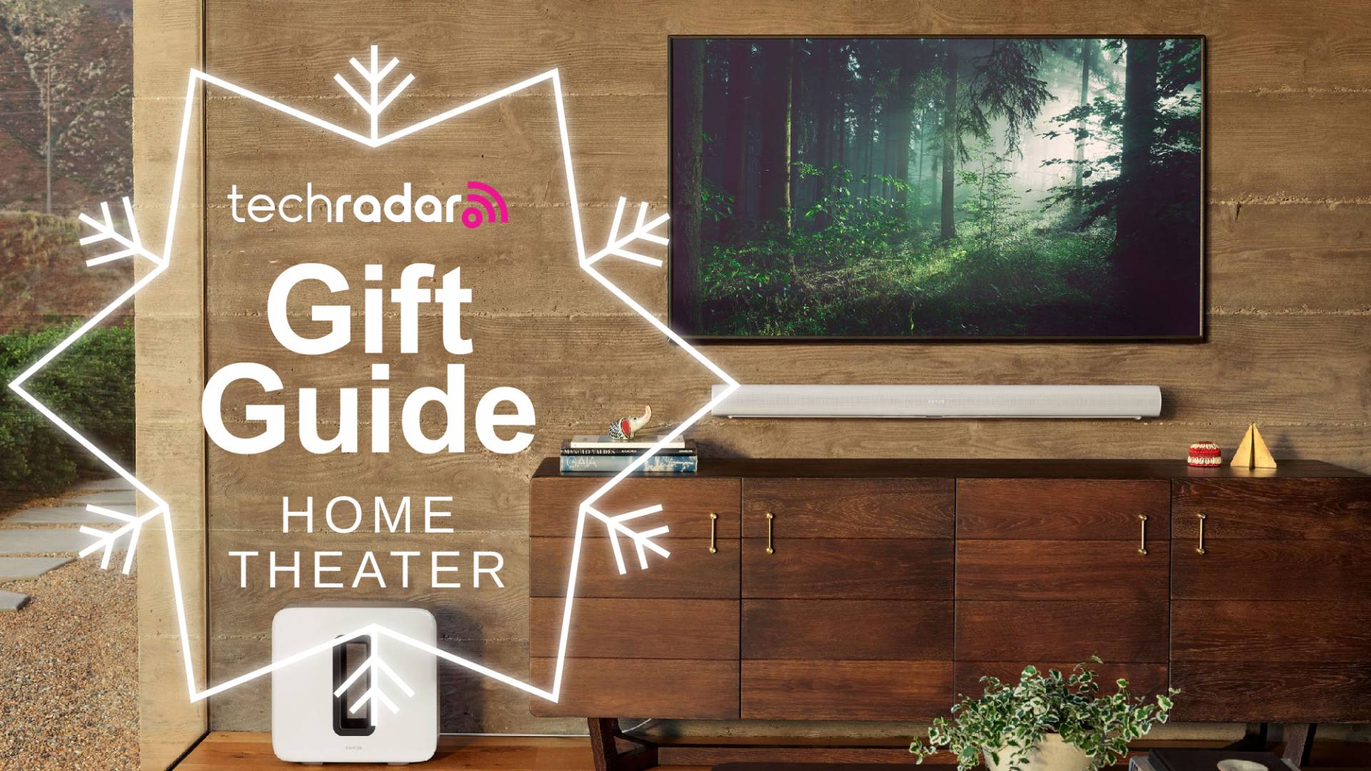 sonos arc soundbar mounted on wall beneath TV with Sonos sub and TechRadar gift guide logo