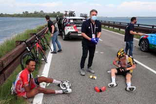 Team JumboVisma rider Netherlands Jos Van Emden R and Team Cofidis rider Eritreas Natnael Berhane L sit on the ground after a massive pack crash during the 15th stage of the Giro dItalia 2021 cycling race a 147km race between Grado and Gorizia on May 23 2021 Photo by Luca Bettini AFP Photo by LUCA BETTINIAFP via Getty Images