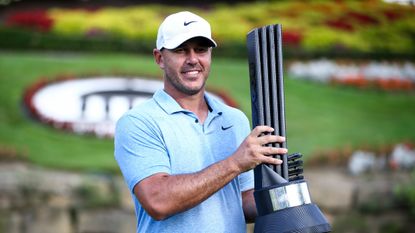 Brooks Koepka poses with the LIV Golf Greenbrier trophy