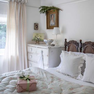 white vintage bedroom with antique furniture and paintings