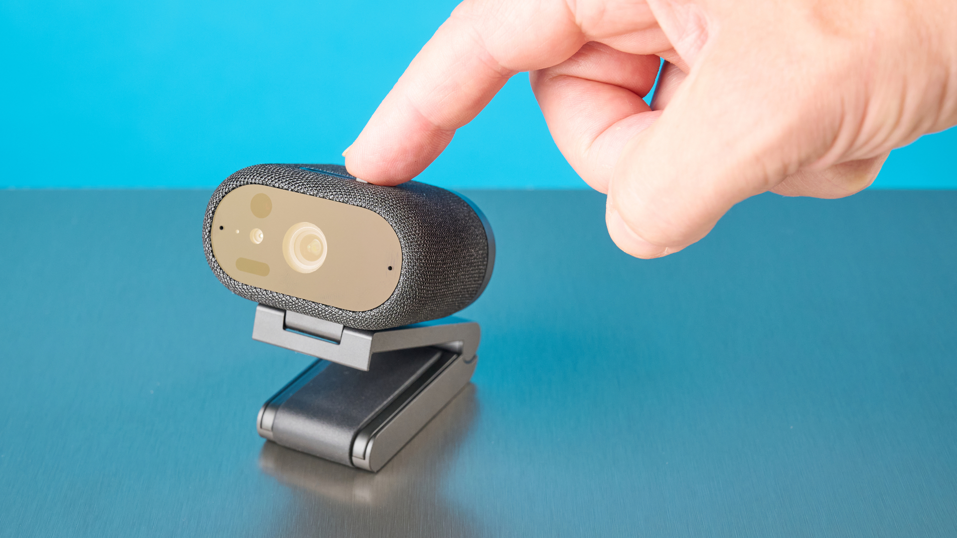 Dell Pro 7 Webcam photographed in front of a blue background