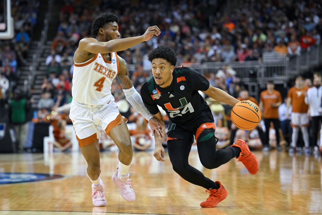 Miami Hurricanes guard Nijel Pack #24 drives against Texas Longhorns guard Tyrese Hunter #4 during the Elite Eight round of the 2023 NCAA Men&#039;s Basketball Tournament.