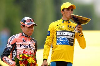 Cadel Evans on the podium as Alberto Contador kisses the winners trophy