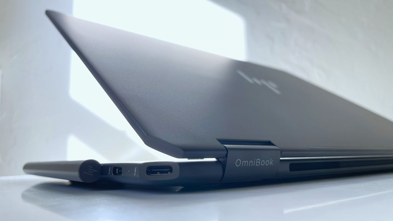 A close up of the bottom corner of a laptop showing its logo and ports.