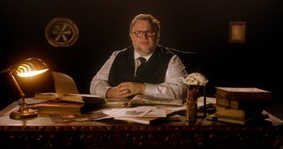 Guillermo Tel Toro sitting behind a desk