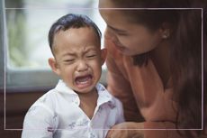 boy crying with mum comforting him