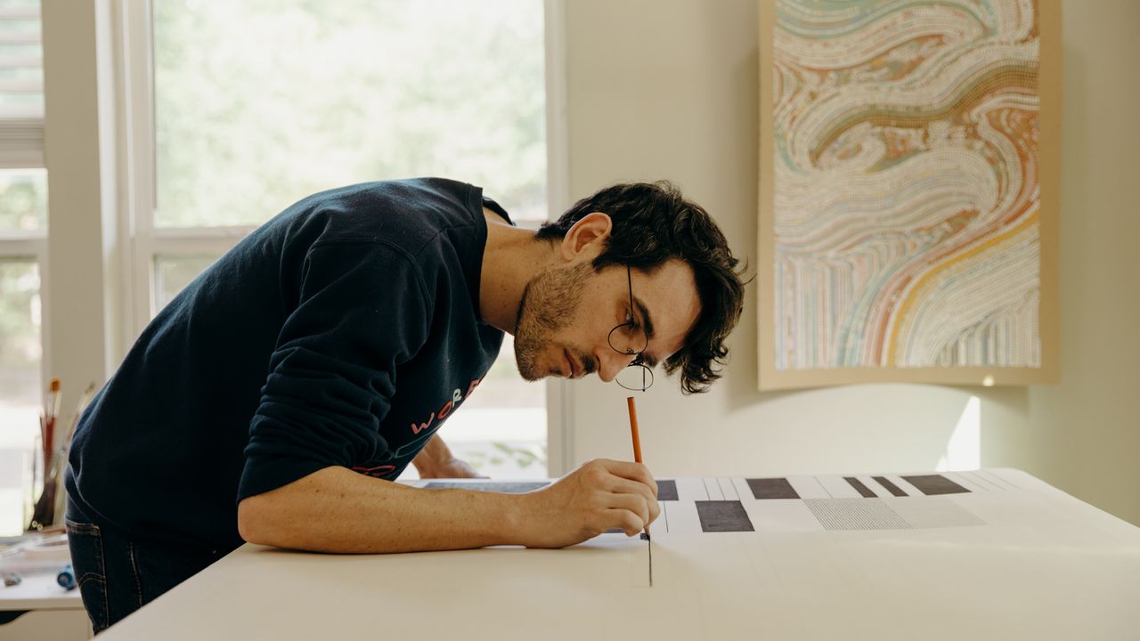 Tyler Hobbs works on a generative artwork in his studio