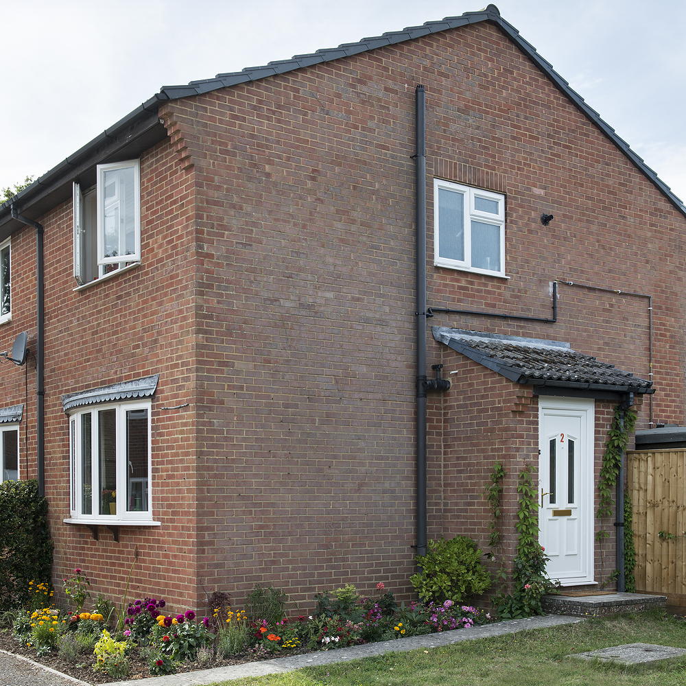 house brick wall with white wall