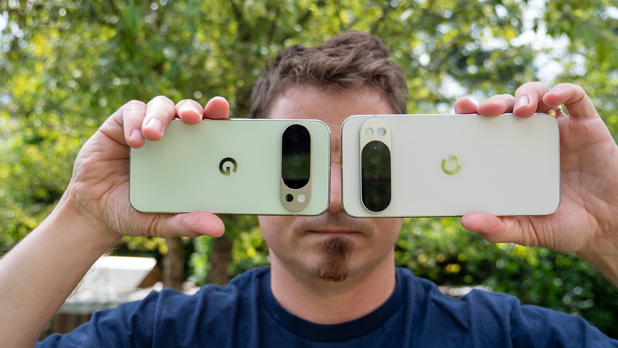 Holding up the Jade Google Pixel 10 Pro and Porcelain Pixel 10 Pro XL to show the backs and camera islands