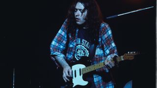 Rory Gallagher performs on stage in London, 1975.
