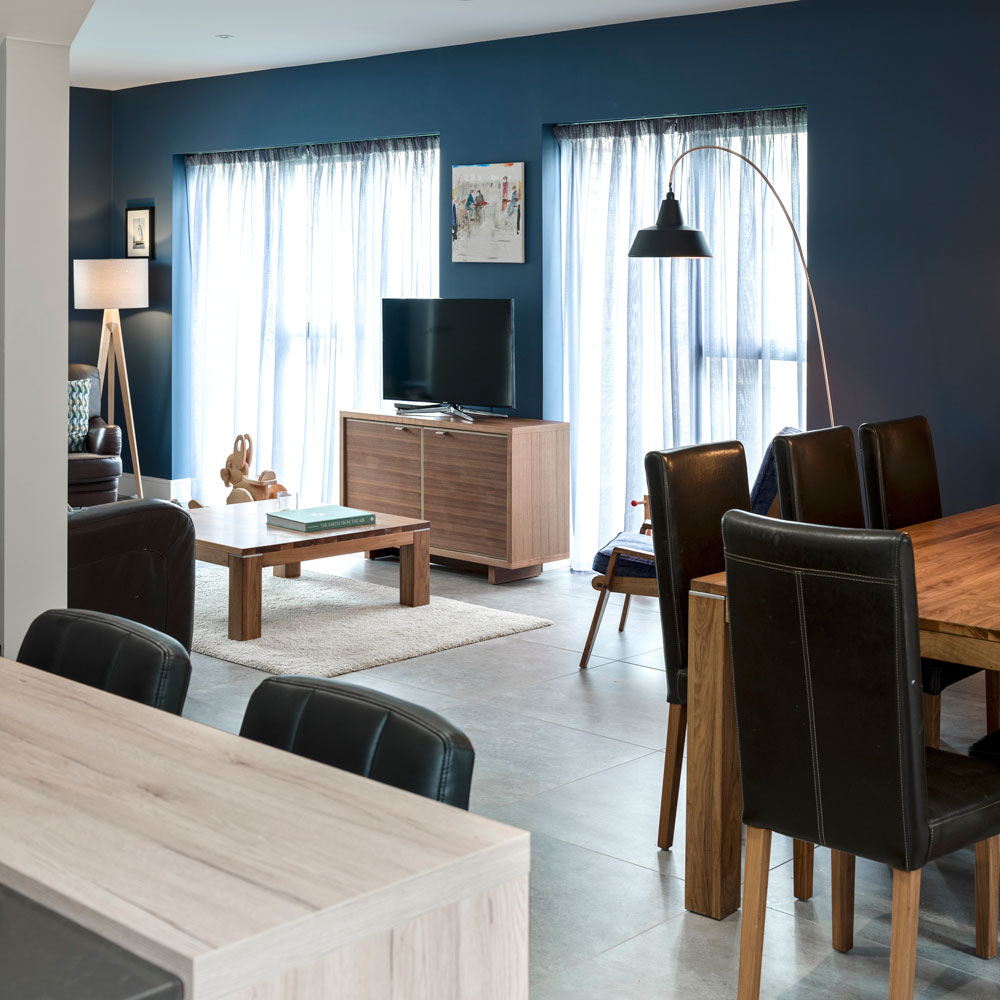 sitting room with wooden dining table and teapoy