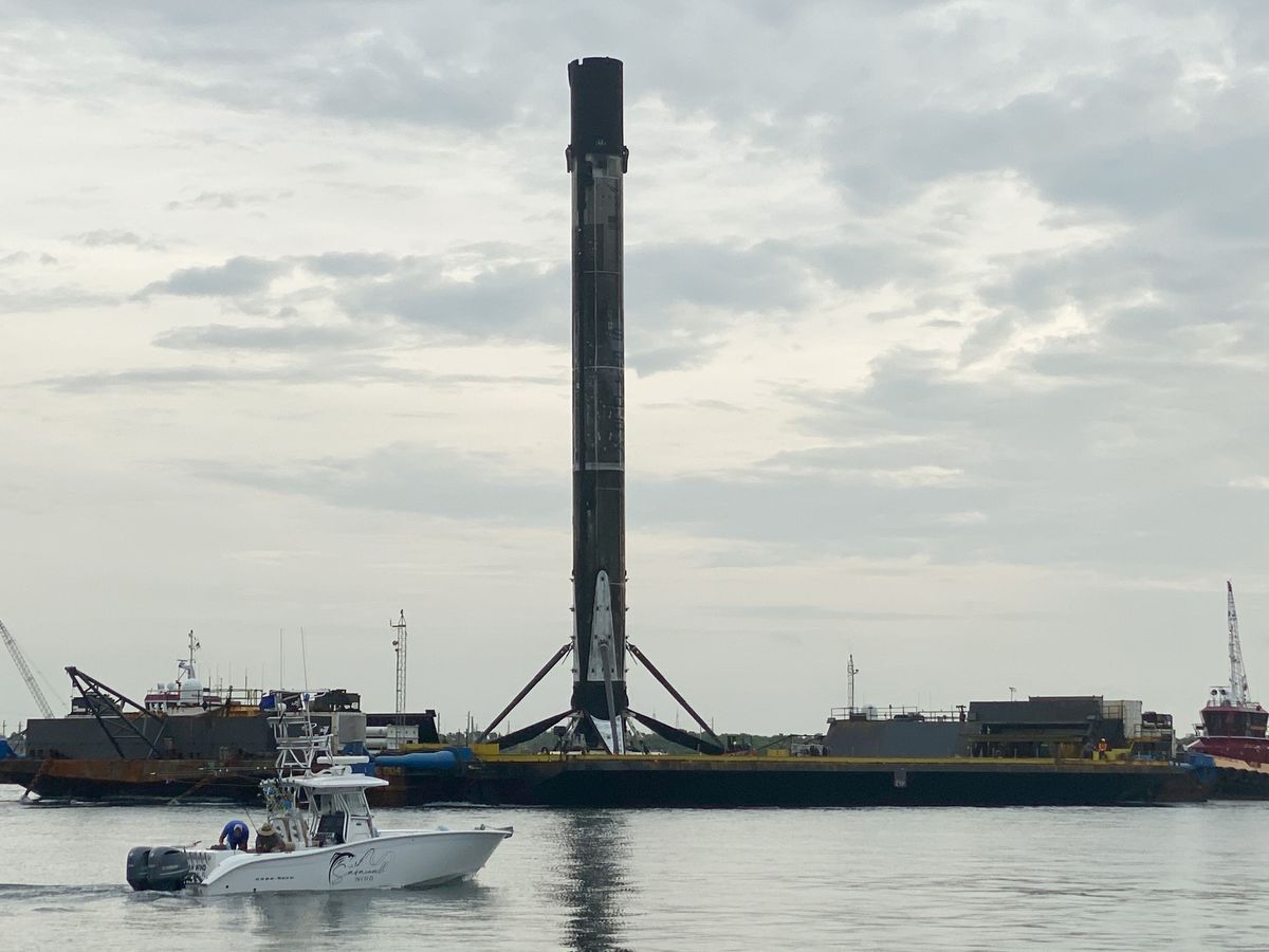 SpaceX's first Falcon 9 booster to fly six times returns home to Port Canaveral in Cape Canaveral, Florida on Aug. 21, 2020 atop the drone ship landing platform Of Course I Still Love You. The rocket launched 58 Starlink satellites and three Planet SkySats from Cape Canaveral Air Force Station on Aug. 18.