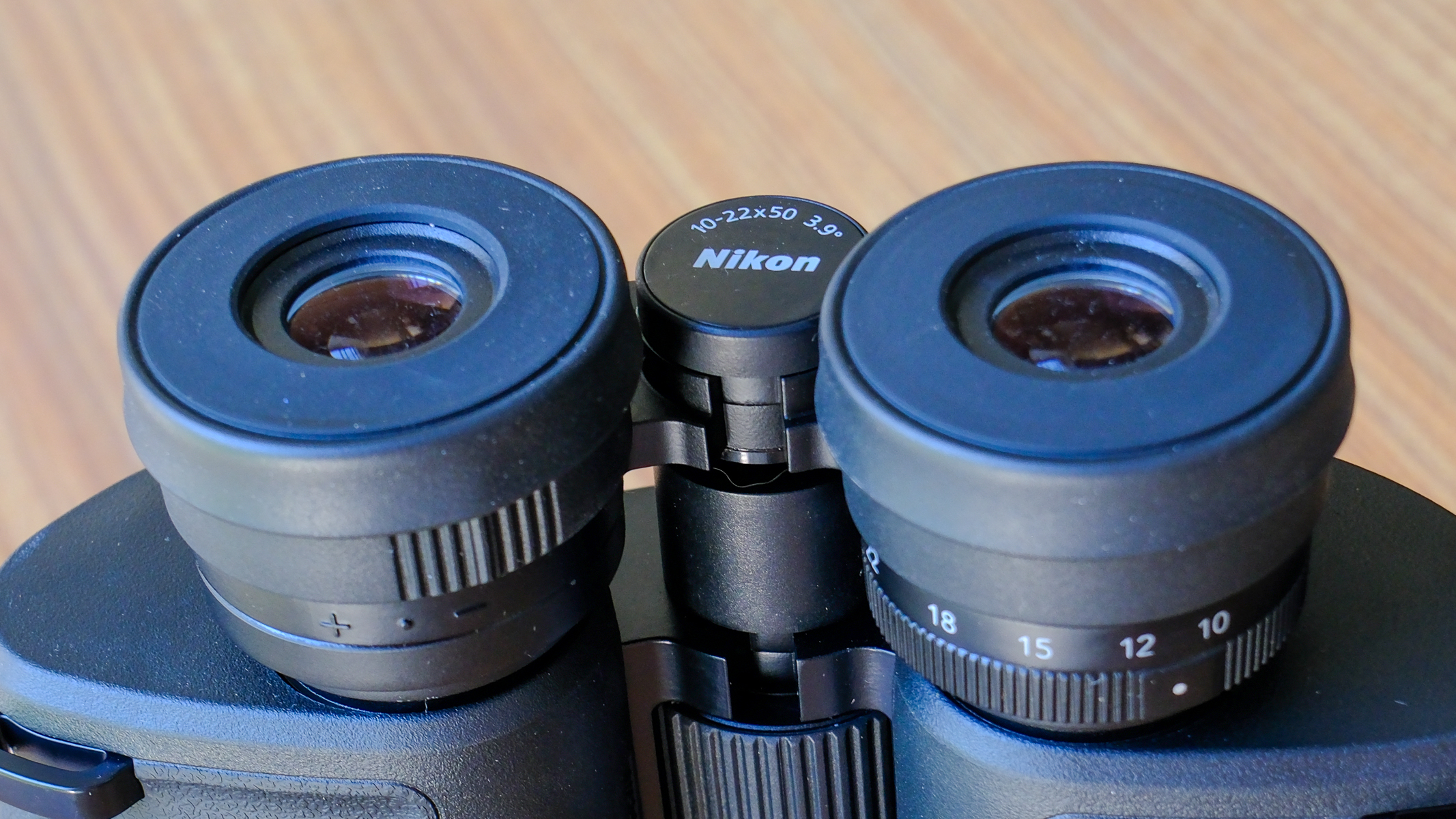 A close-up of the folded down eyecups on the Nikon Action Zoom 10-22x50 binoculars.