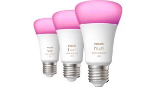 Three Philips Hue smart bulbs in a row on a white background