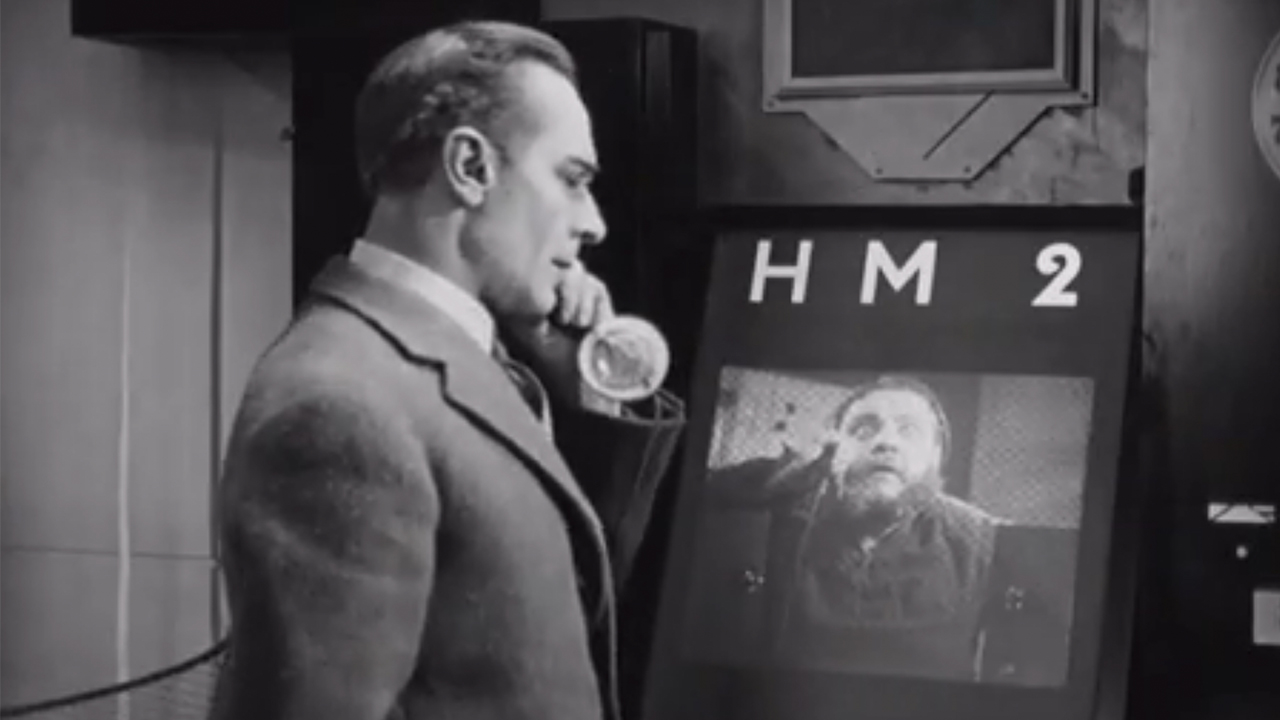 A man talking on a video phone in Metropolis