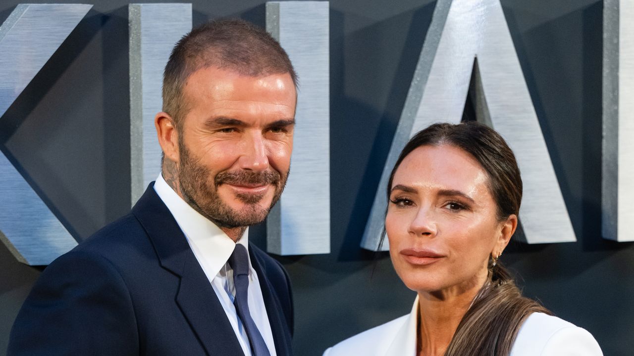 Victoria Beckham poses with her husband, David Beckham. 