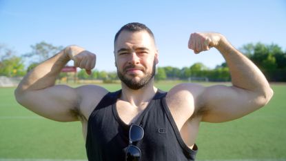 Alex Solomin, fitness coach, flexing for the camera