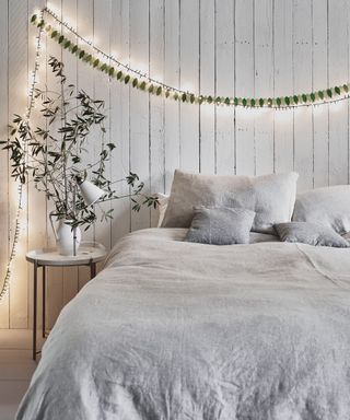 White bedroom dressed with fairy lights
