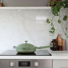 Kitchen with marble worktops, grey cabinets, and hob with Our Place Always Pan