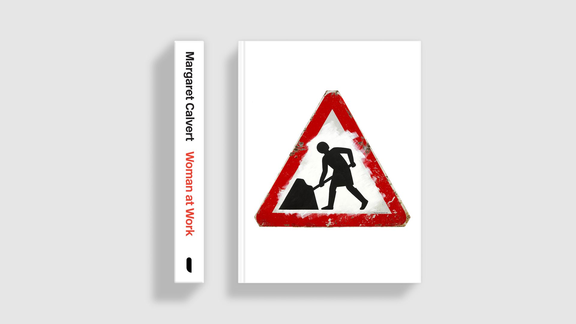 Book cover featuring road sign showing woman at work