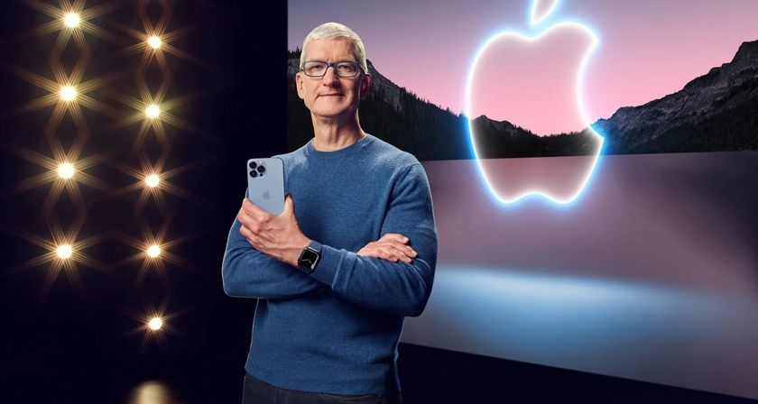 Tim Cook with iPhone in front of Apple logo 