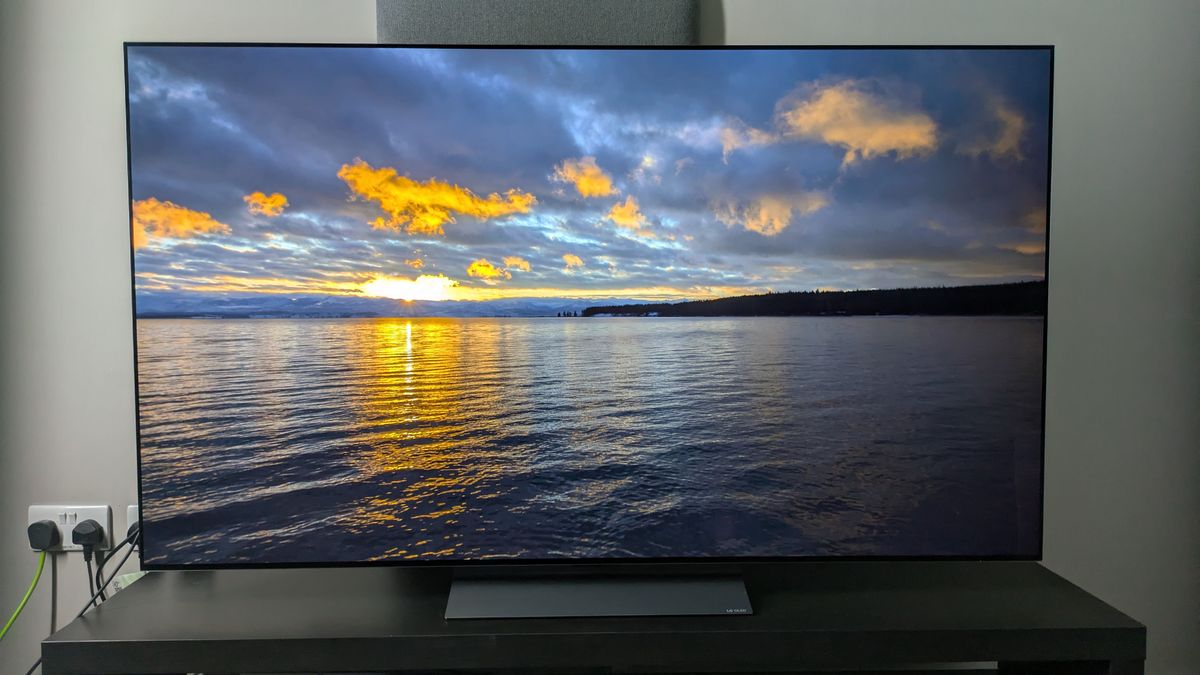 LG C5 with sunset over ocean on screen