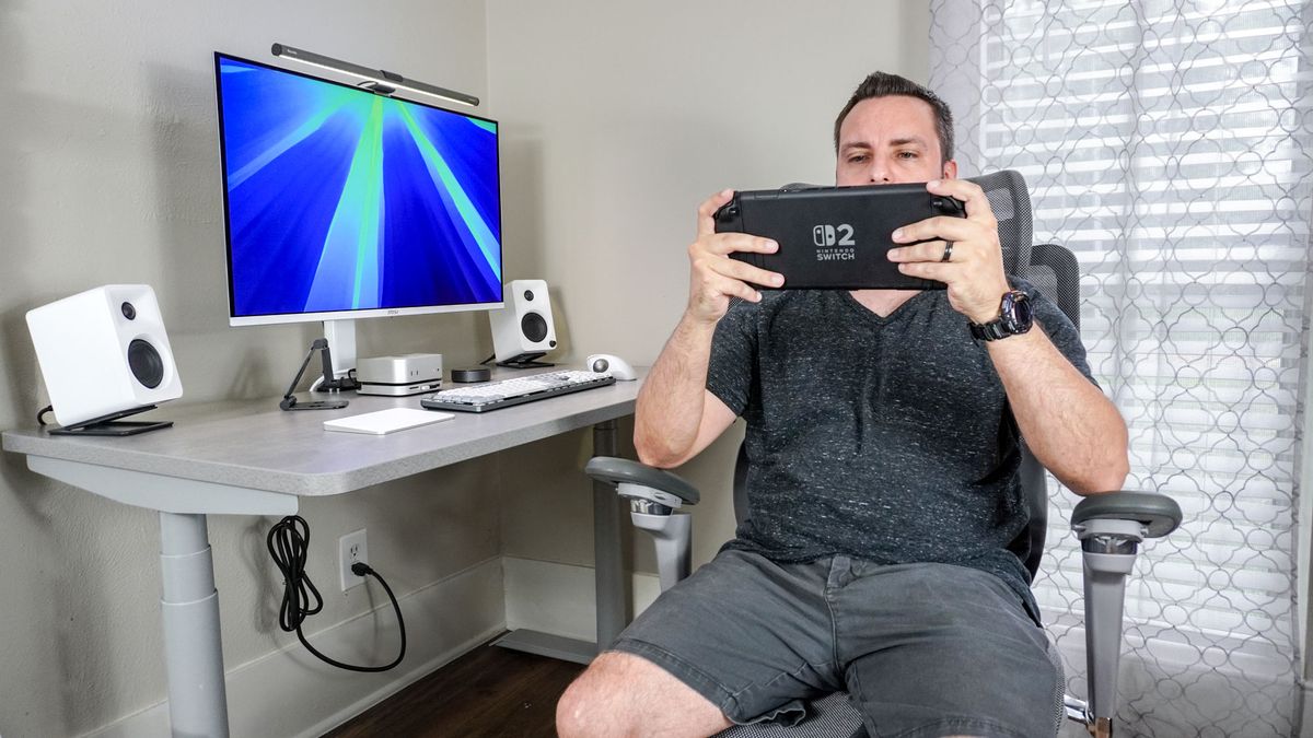 A person using the Hinomi X1's rotating armrests to comfortably play the Switch 2