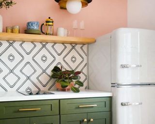 Kitchen with pink walls and green cabinets
