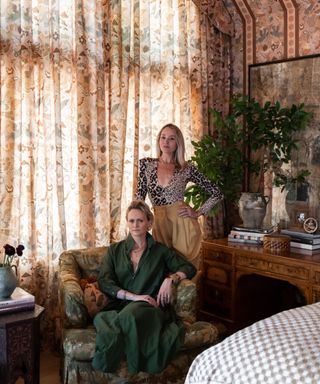 Louise Pierce and Emily Ward pose in front of the House of Hackney collection