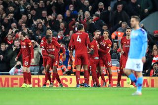Sadio Mane, centre right, celebrates scoring Liverpool's third goal against City at Anfield