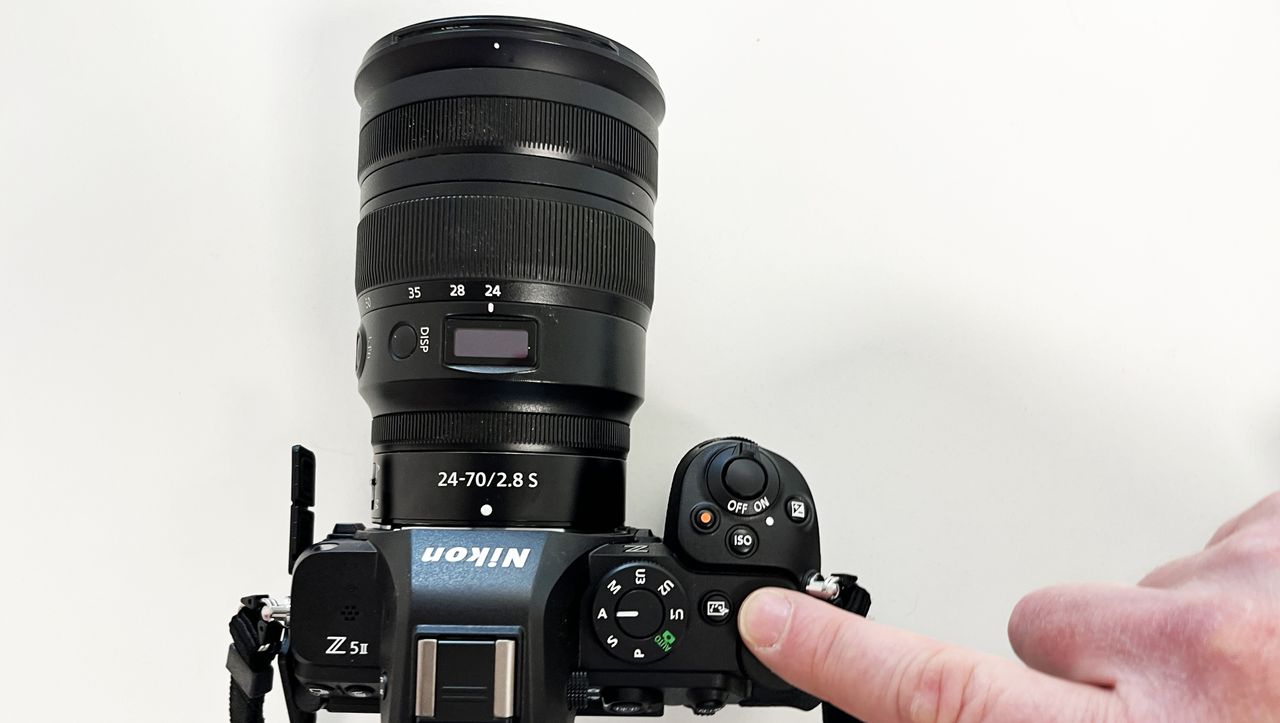 Nikon Z5 II camera with finger pointing to Picture Control button