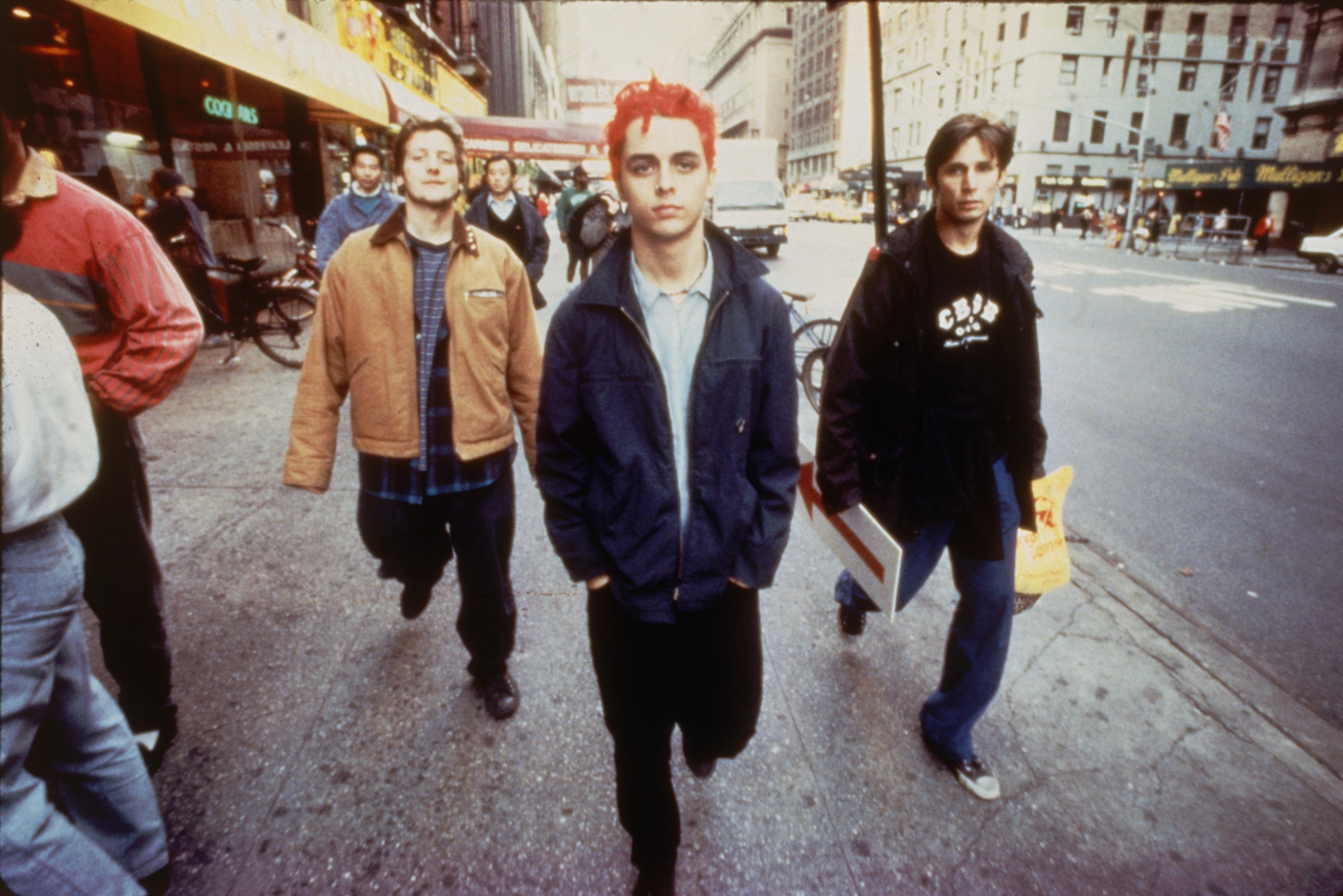 Punk rock trio Green Day (L-R) bassist Mike Dirnt, vocalist &amp; guitarist Billie Joe (Armstrong) &amp; drummer Tre Cool sauntering streets of NYC.