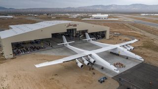 The massive Stratolaunch Systems carrier plane for aerial rocket launches rolls out of its Mojave Air and Space Port hangar in Mojave, California for the first time on May 31, 2017. The aircraft will launch rockets from high-altitude.