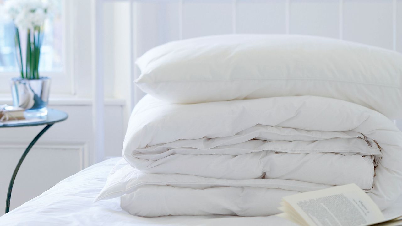 White bedding on top of mattress