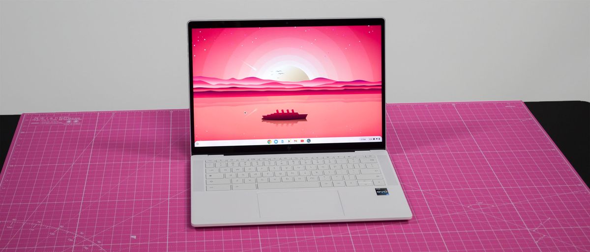 An HP Dragonfly Pro Chromebook on a ruled pink desk mat