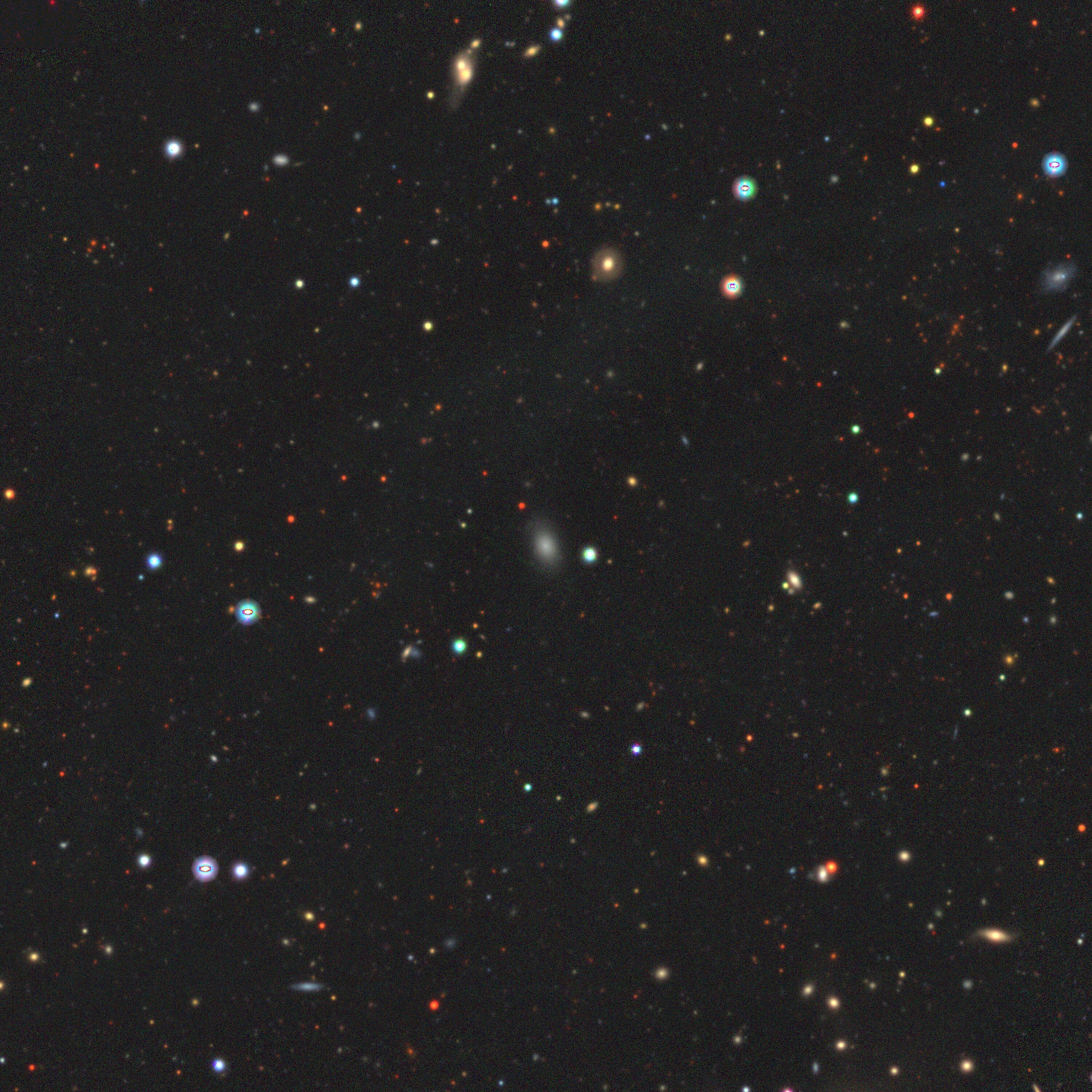 A photo of stars and galaxies in deep space, with a white smudge showing the runaway dwarf galaxy